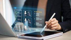 Businesswoman using tablet and stylus with holographic HR dashboard showing candidate profiles and ratings; concept of recruitment analytics, applicant tracking, talent management, and hiring workflow.