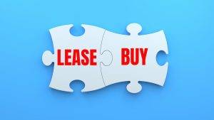 lease vs buy, puzzle pieces. concept of lease vs buy copier.